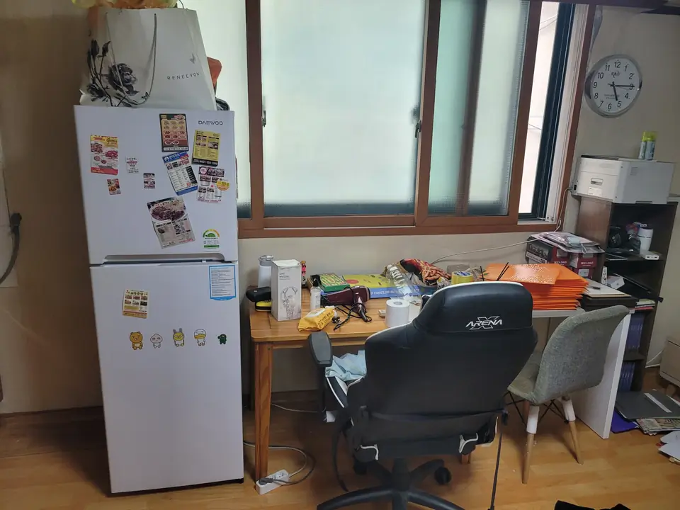 책상과 냉장고가 놓인 방 내부